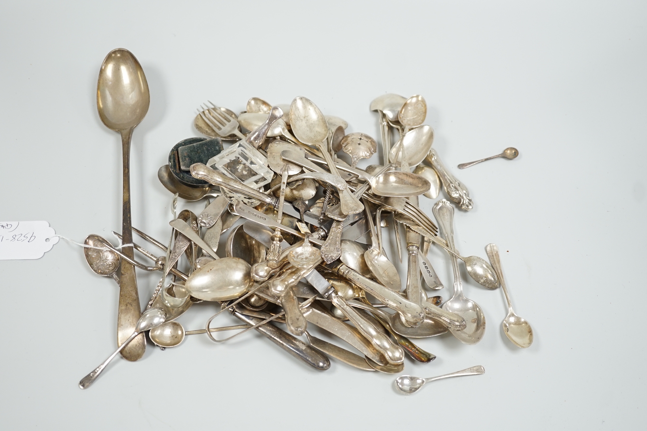 Sundry silver and white metal flatware including a George III silver Old English pattern basting spoon, London, 1782, teaspoons, condiments spoons, sifter spoon, caddy spoon etc.